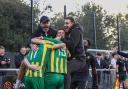 Harpenden Town manager Micky Nathan (left) celebrates with his players after the late winner. Picture: TOBY HOWE