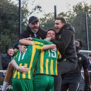 Harpenden Town manager Micky Nathan (left) celebrates with his players after the late winner. Picture: TOBY HOWE