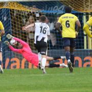 Michael Johnson saves the injury-time penalty for St Albans City against Bath. Picture: JIM STANDEN