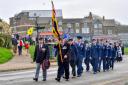 Simon Matthews (front. left) and standard bearer Ralph Hamlet lead the Remembrance Sunday parade to the war memorial at Hunstanton