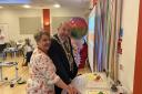 Valerie Skottowe and Mayor Frank Marsh cutting the anniversary cake