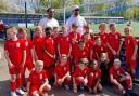 Anton and Rio Ferdinand with a team of young footballers.