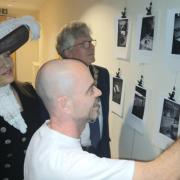 Christopher Hall showing the exhibition to High Sheriff Annie Brewster and Mayor Jamie Day