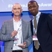 Tony is presented with his award by the Parole Board's Faith Leary and BBC anchor Clive Myrie